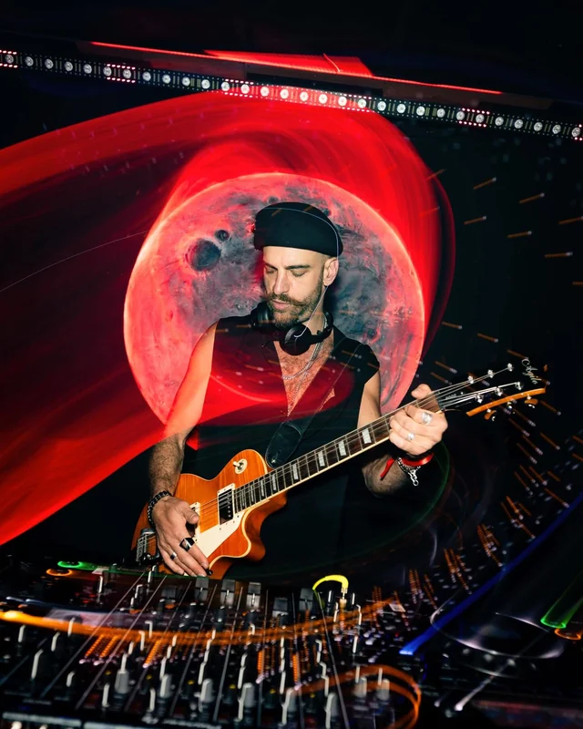 OFIER performing with a guitar